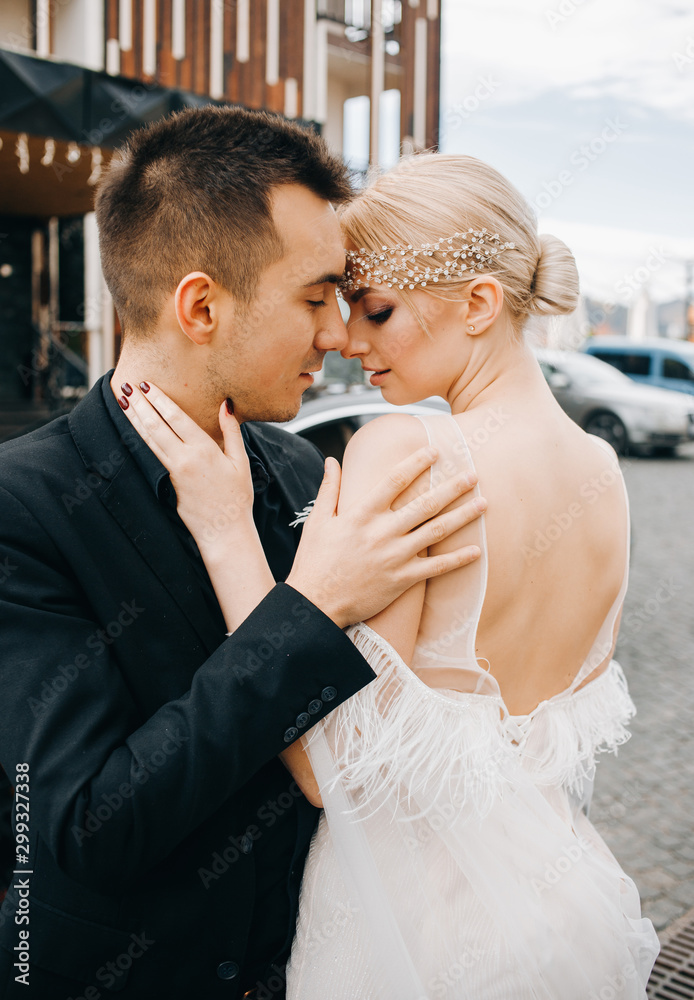 Luxury couple embracing near black car. Luxury couple embracing near black car.