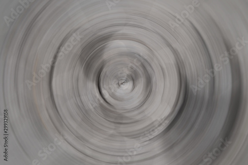 Blurred radial motion gradient dark gray background. Circular brushed texture