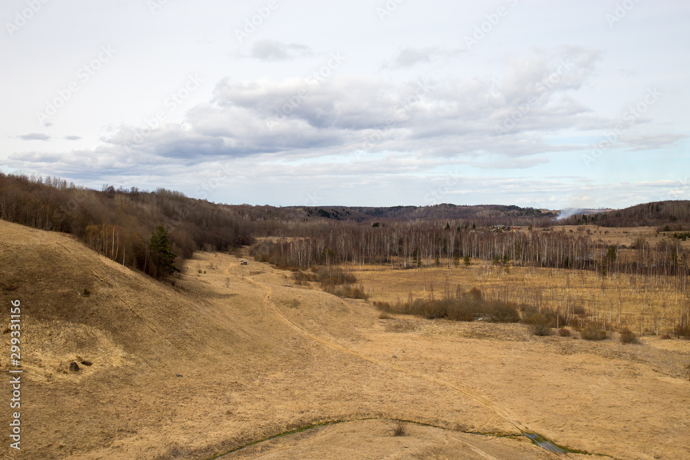 Panorama of spring landscape with hills and forests. Izborsk, Pskov region, Russia.