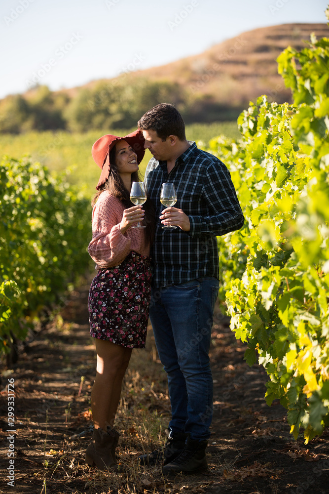 Happy husband and wife in a vineyard on the country side Happy husband and wife in a vineyard on the country side