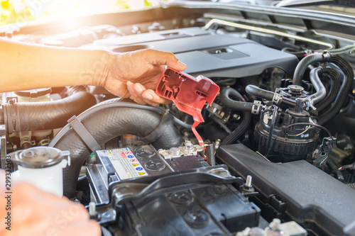 Selective focus, Technician man hand checking car battery on car engine system