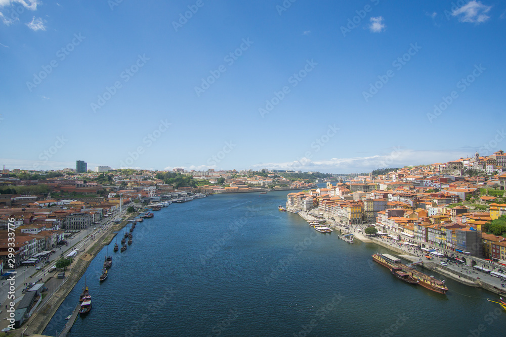 Panoramic view of Porto city , the beautiful buildings and their colorful rooftops from both sides and the douro river below , was captured from the Luís I iconic bridge Bridge
