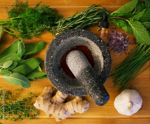 Herbs and spices laid out around Mortar, ready to be crushed. photo