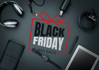 Top view of gadgets with black friday lettering on black background. Copyspace for your ad. Black friday, sales, finance, advertising, money, finance, purchases concept. Headphone, watch, tablet.