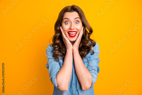 Photo of curly wavy ecstatic girlfriend youngster excited about sales started at shopping mall isolated over vivid color yellow background