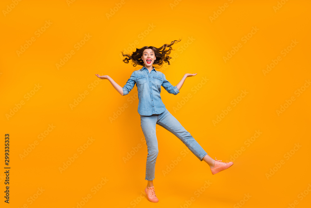 Full length body size photo of cheerful ecstatic attractive pretty girlfriend throwing up her hair behaving like child wearing sneakers isolated vivid color yellow background Full length body size photo of cheerful ecstatic attractive pretty girlfriend throwing up her hair behaving like child wearing sneakers isolated vivid color yellow background
