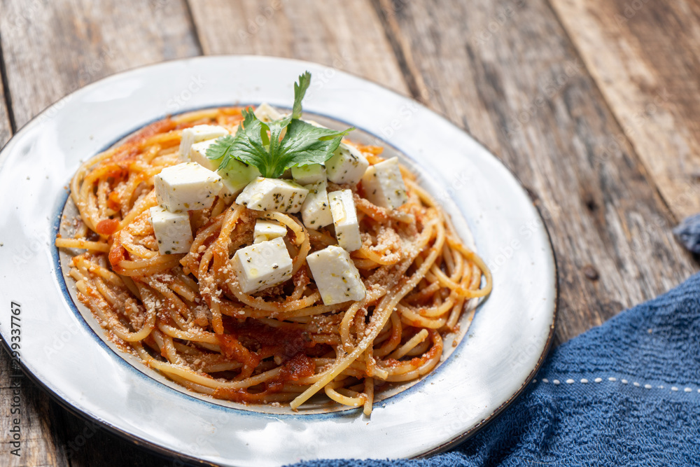 Spaghetti pasta with fresh and parmesan cheese on wooden background Spaghetti pasta with fresh and parmesan cheese on wooden background