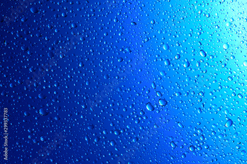 Sparkling water droplets on translucent blue