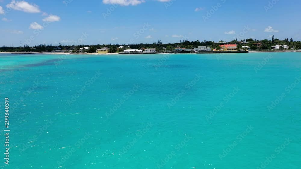 Aerial: Waterfront Homes Looking Over Clear Blue Tropical Water on a Sunny Day - Nassau, Bahamas Aerial: Waterfront Homes Looking Over Clear Blue Tropical Water on a Sunny Day - Nassau, Bahamas