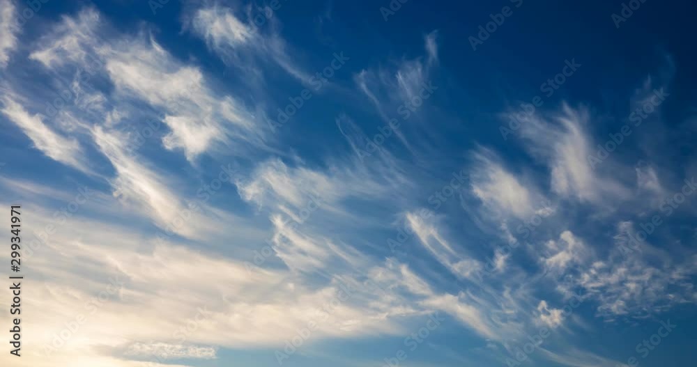 cirrus clouds flying against a blue sky