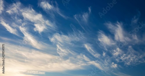 cirrus clouds flying against a blue sky photo