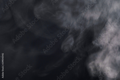 white smoke or steam on a black background