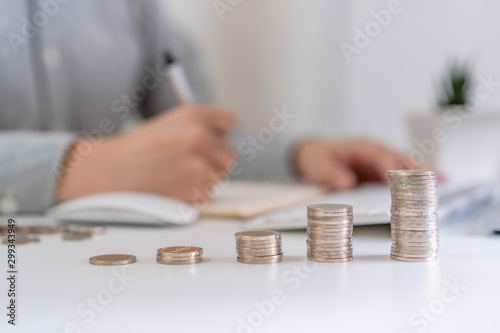 investment concept, pile of growth coins with working office man background