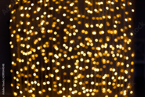 Christmas and New Year golden yellow background with abstract blurred highlights. Bokeh in blur.