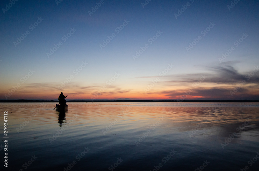 The fisherman and boat silhouette