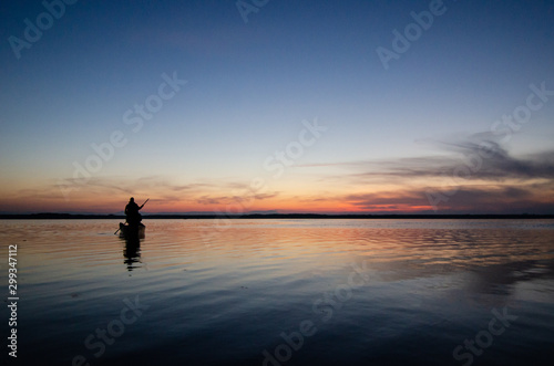 The fisherman and boat silhouette © nkeskin