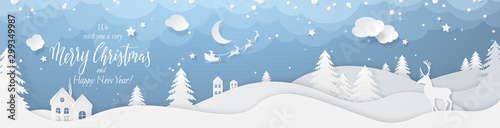 Winter landscape with deer paper cut-out and fir trees in snow. Festive horizontal banner with text Merry Christmas, Village and flying santa's sleigh in night sky with stars, snowfall and moon.