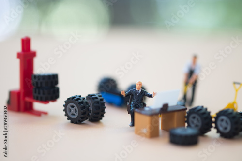 Miniature people : Concept of car maintenance and service center.