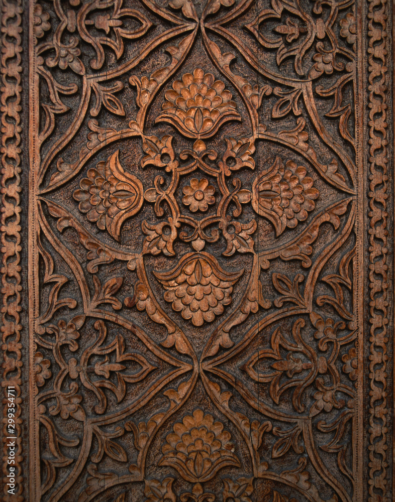 Beautiful ancient dark wood carving detail, carved in a traditional uzbek style, Uzbekistan carving wood, intricate carving with Uzbek motifs, complex wood carving, top view, vertical image