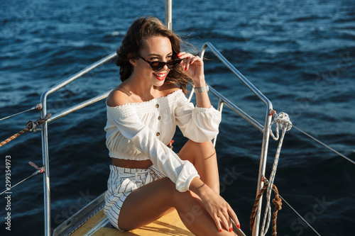 Amazing woman outdoors on yacht in sea.