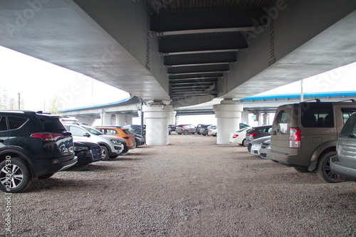 car parking under a flyover on a cloudy day