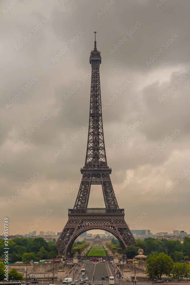 Perfect portrait view of the famous iconic Eiffel Tower from the Chaillot hill on a cloudy hazy summer morning in Paris. The Eiffel Tower is the most-visited paid monument in the world.