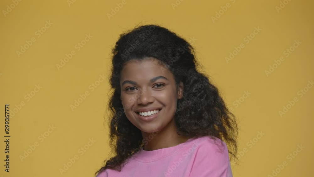 smiling african american girl showing peace signs isolated on yellow smiling african american girl showing peace signs isolated on yellow