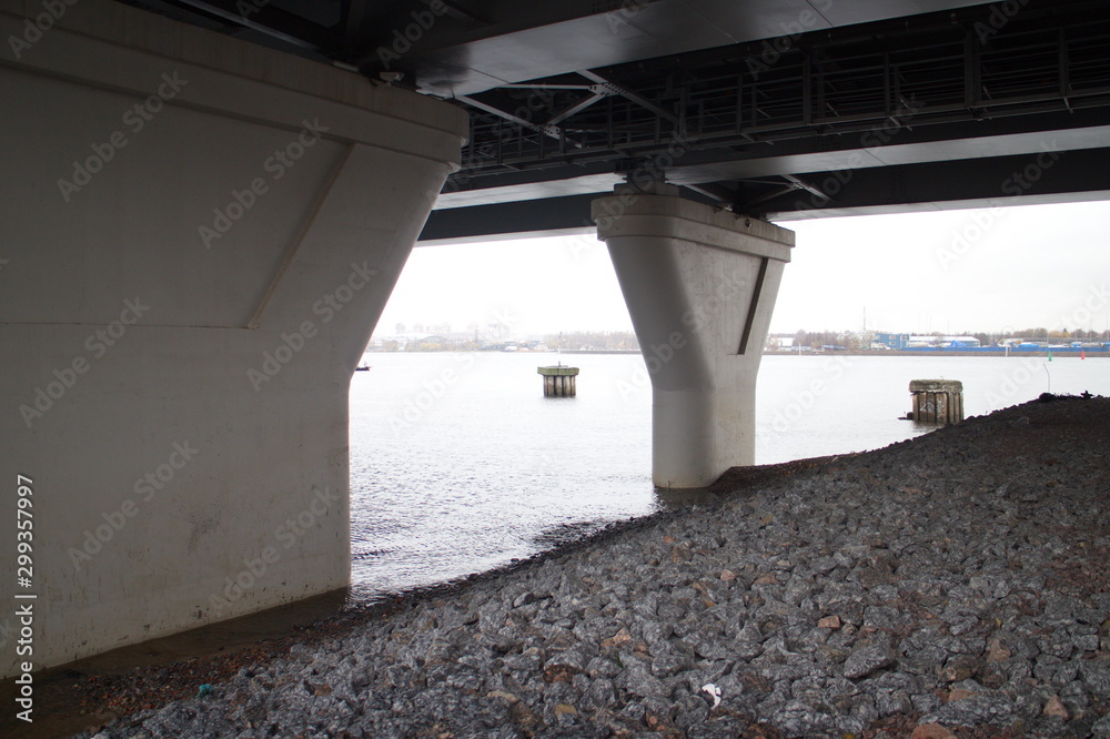 large transport overpass by the river on a cloudy day large transport overpass by the river on a cloudy day