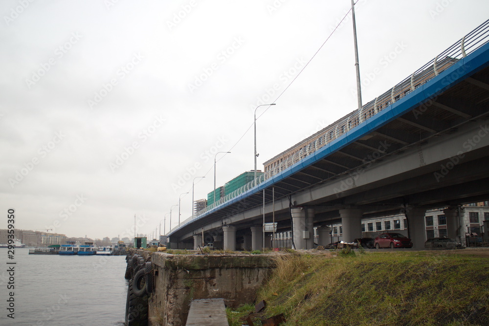 large transport overpass by the river on a cloudy day large transport overpass by the river on a cloudy day