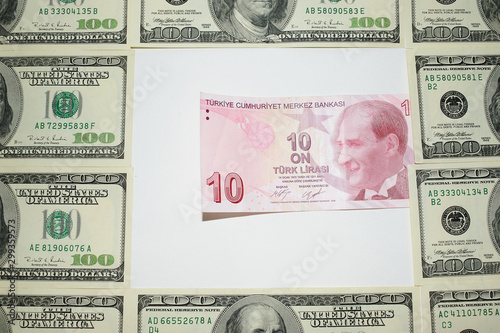 a ten Turkish Lira note surrounded by one hundred American dollars