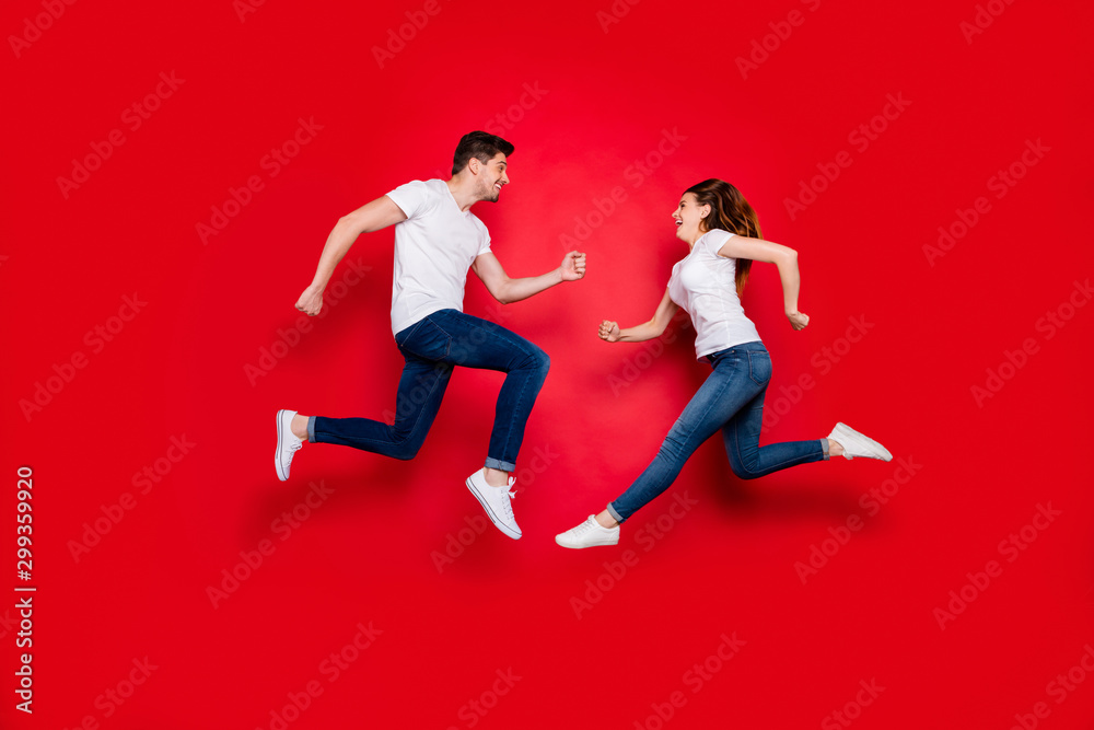Side profile full length body size photo of cheerful positive pretty couple boyfriend girlfriend running into each other jumping jeans denim white t-shirt footwear isolated vivid color background Side profile full length body size photo of cheerful positive pretty couple boyfriend girlfriend running into each other jumping jeans denim white t-shirt footwear isolated vivid color background