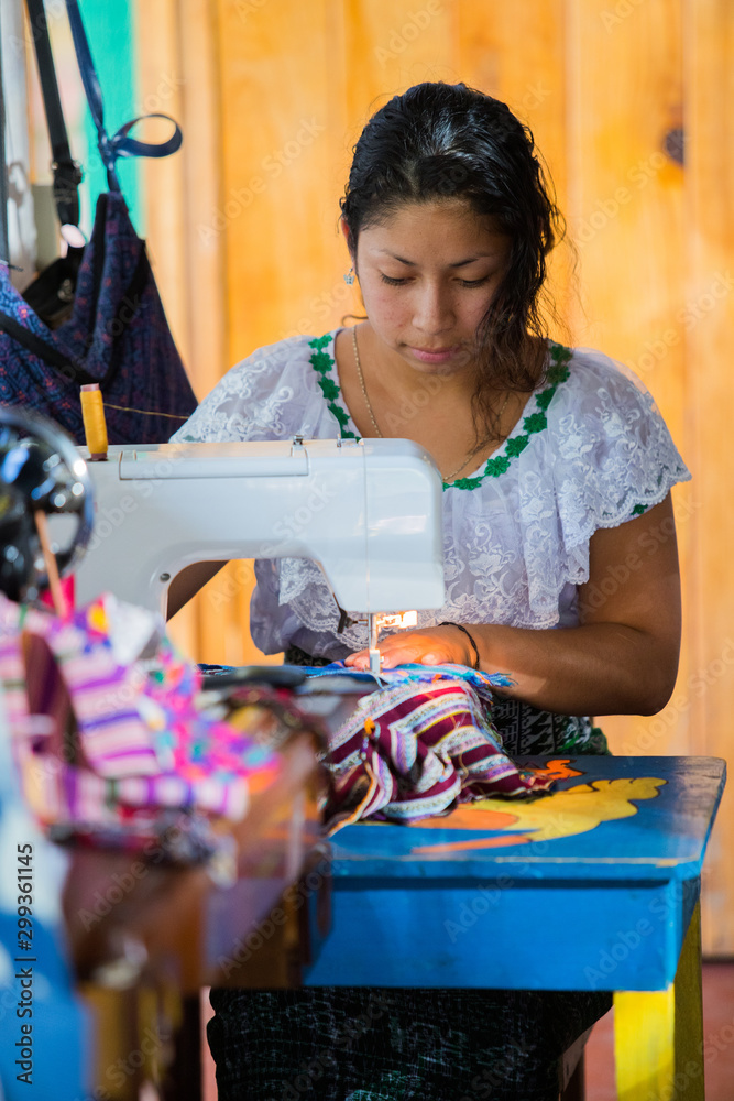 Guatemalan woman working with textiles in in San Juan La Laguna, Lake Atitlan, Guatemala