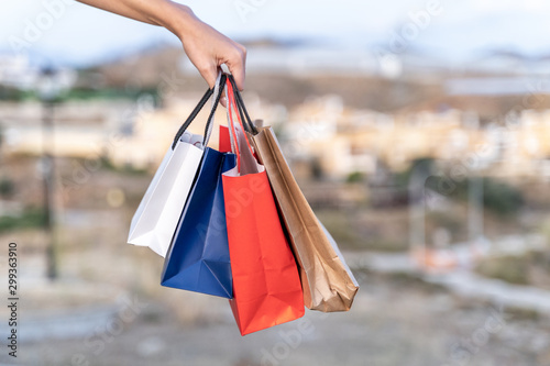 women's hands holding some shopping bags. Shopping concept