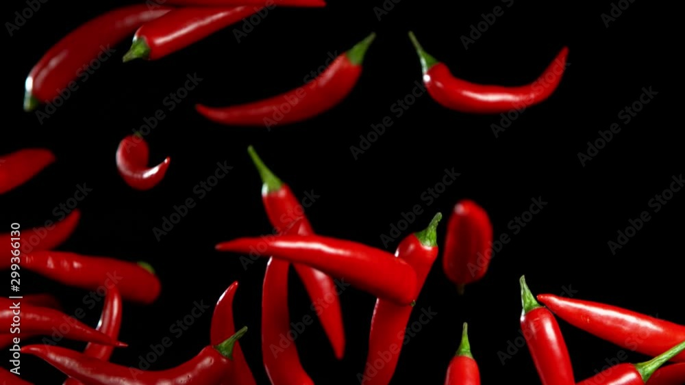 Super slow motion of flying red hot chilli peppers with speed ramping effect. Filmed on high speed camera, 1000 fps Super slow motion of flying red hot chilli peppers with speed ramping effect. Filmed on high speed camera, 1000 fps