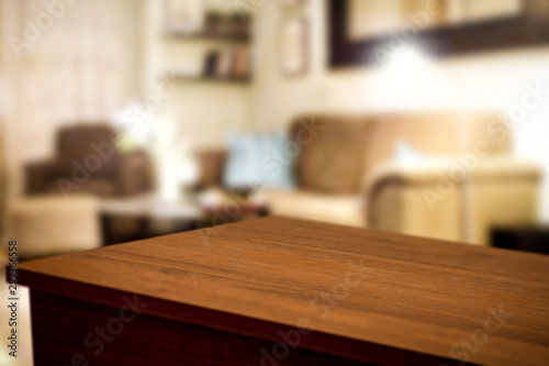 Wooden corner table background of free space for your decoration and blurred home interior 