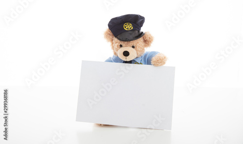 Cute teddy in policeman uniform isolated against white background