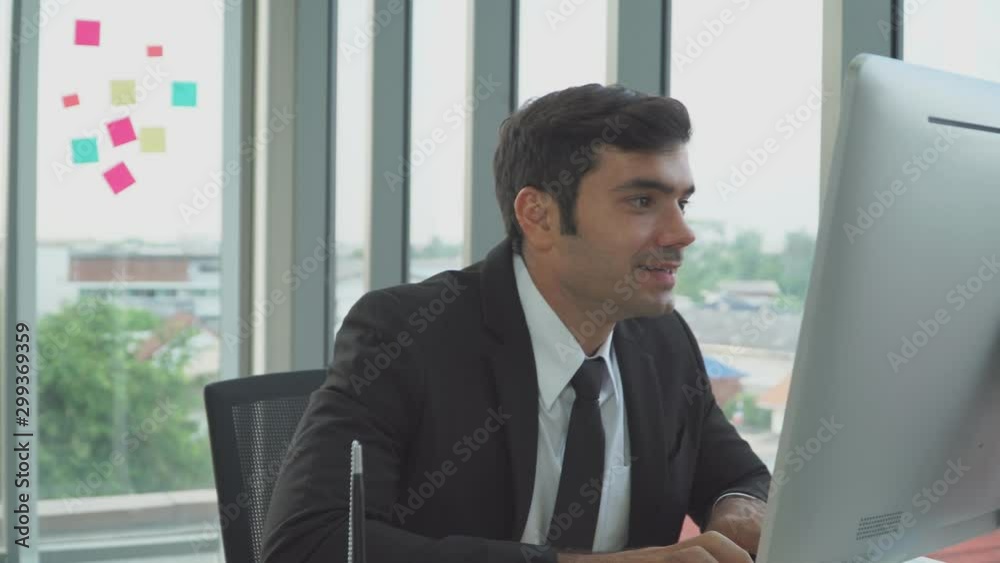 A businessman is excited and happy when he receives good news from his email box. A businessman is excited and happy when he receives good news from his email box.