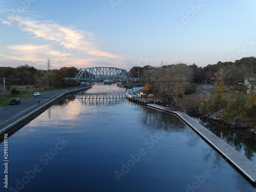 calm water reflection in canal with bridge in Hamptons 