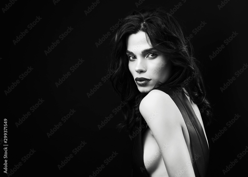Fashion vogue style studio portrait. Young sexy girl in black leather dress and ring, posing on the black background. Woman vogue style black leather. Beautiful long black straight hair and make up. Fashion vogue style studio portrait. Young sexy girl in black leather dress and ring, posing on the black background. Woman vogue style black leather. Beautiful long black straight hair and make up.