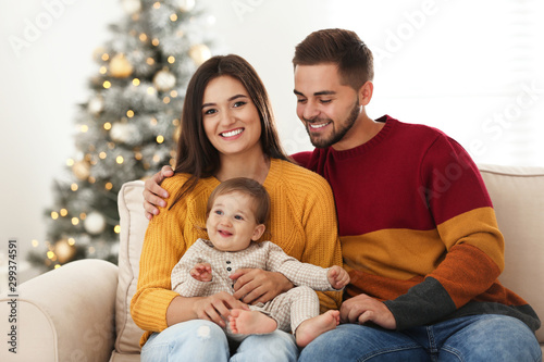 Happy family with cute baby at home. Christmas celebration