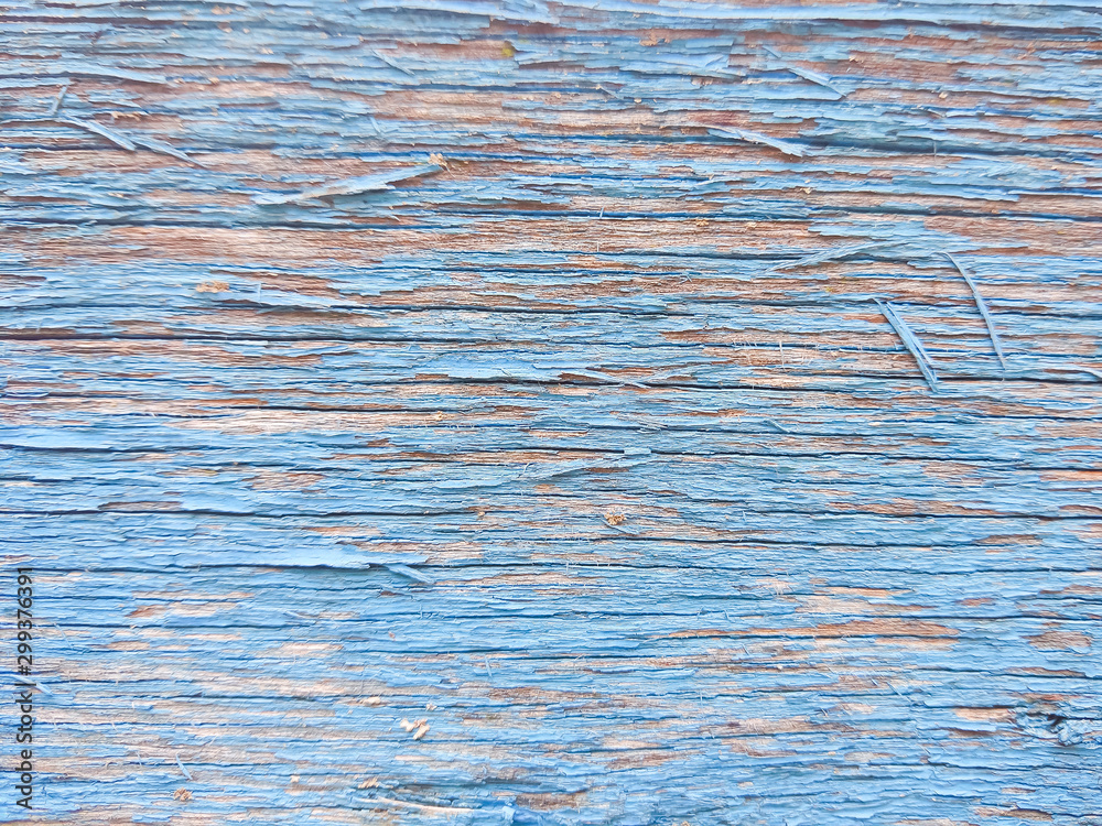 Wood texture with blue flaked paint. Peeling paint on weathered wood. Old cracked paint pattern on rusty background. Chapped paint on an old wooden surface Wood texture with blue flaked paint. Peeling paint on weathered wood. Old cracked paint pattern on rusty background. Chapped paint on an old wooden surface