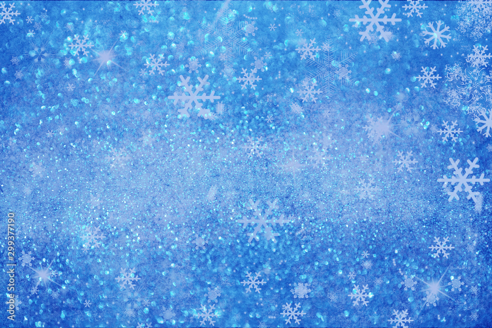 Christmas background with white blurred and clear snowflakes on light blue background.