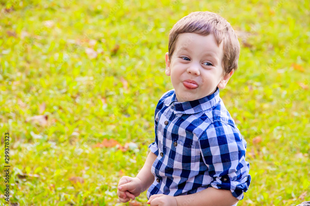 Portrait of a boy in a shirt on the street. Beautiful boy. Little boy. Walk. A child's smile. Portrait of a boy in a shirt on the street. Beautiful boy. Little boy. Walk. A child's smile.
