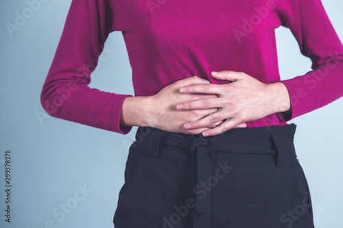 woman hand in ache stomach
