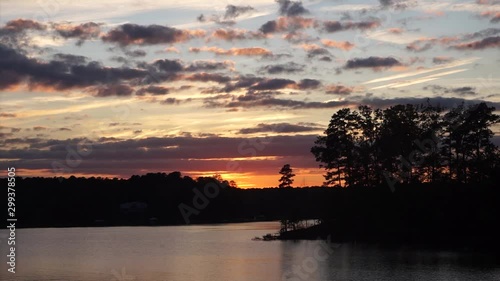 A scenic view of a sunset over a lake. photo