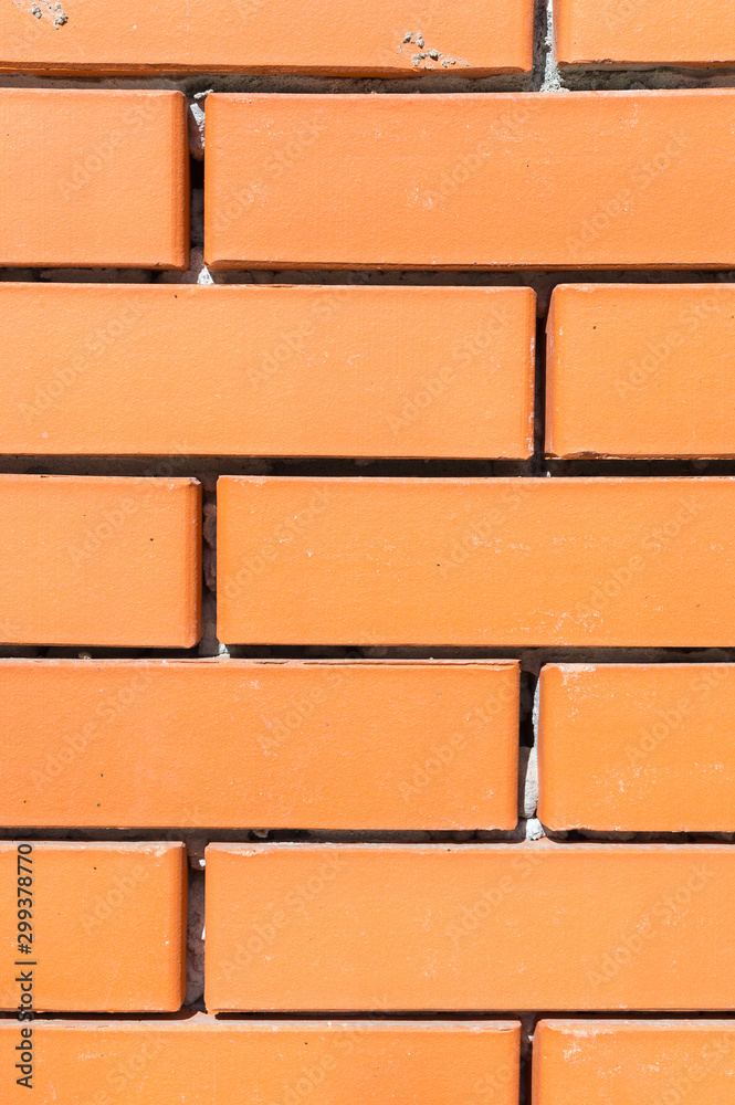 Obraz premium Textured background new brickwork close-up orange brick