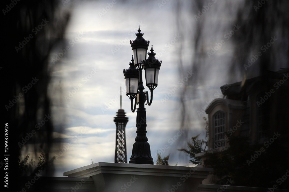 Vintage street lantern on the background of the tower Photos | Adobe Stock