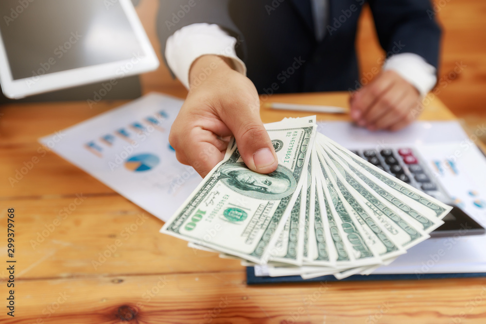 Man offering batch of hundred dollar bills. Man Displaying a Spread of Cash. Man offering batch of hundred dollar bills. Man Displaying a Spread of Cash.