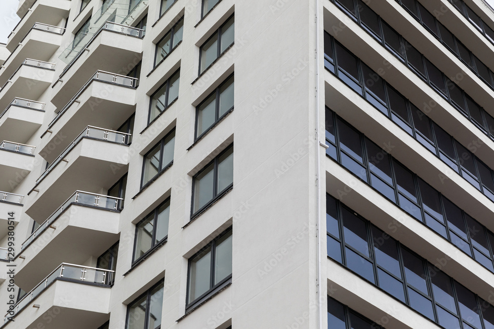 Facade of white parget concrete building surface with windows and balconies Facade of white parget concrete building surface with windows and balconies