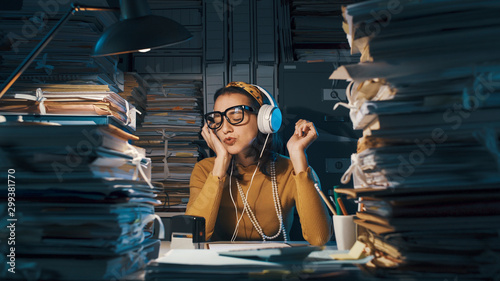 Careless employee listening to music instead of working